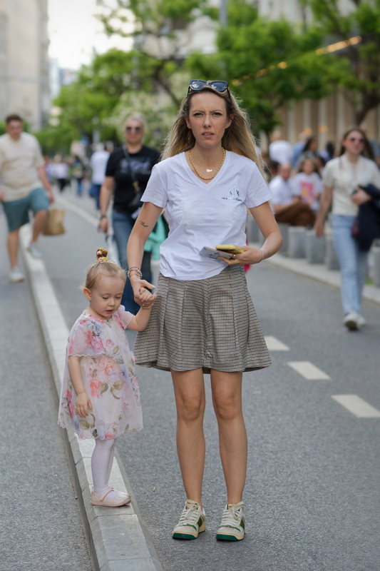 Mother and child walking together on a pedestrian street
